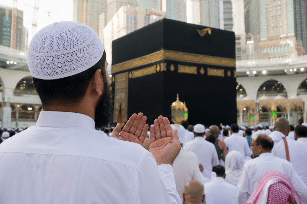 Muslim man making dua in front of the Kaaba during the first 10 days of Dhul Hijjah in Masjid al-Haram, Makkah