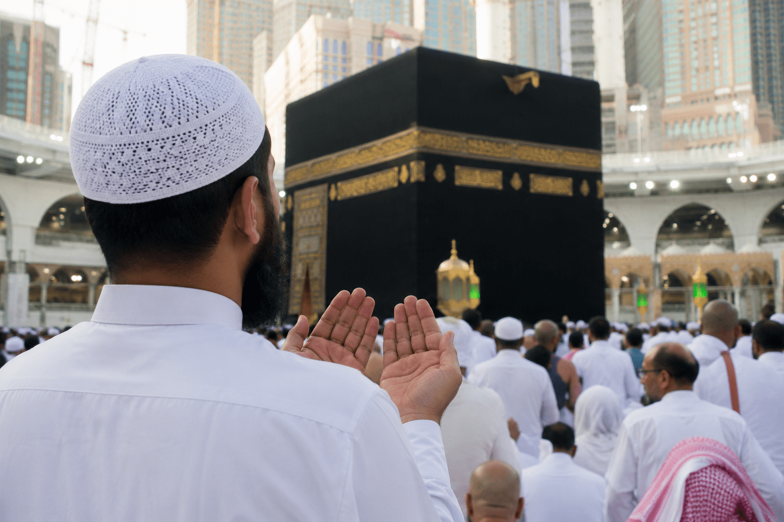 Muslim man making dua in front of the Kaaba during the first 10 days of Dhul Hijjah in Masjid al-Haram, Makkah